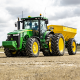 Farm & Ranch Supplies - Green tractor pulling yellow grain trailer